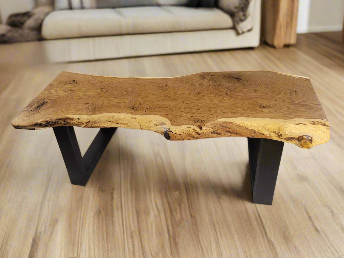 Wooden coffee table with natural edge design on a wooden floor