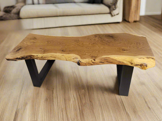 Wooden coffee table with natural edge design on a wooden floor