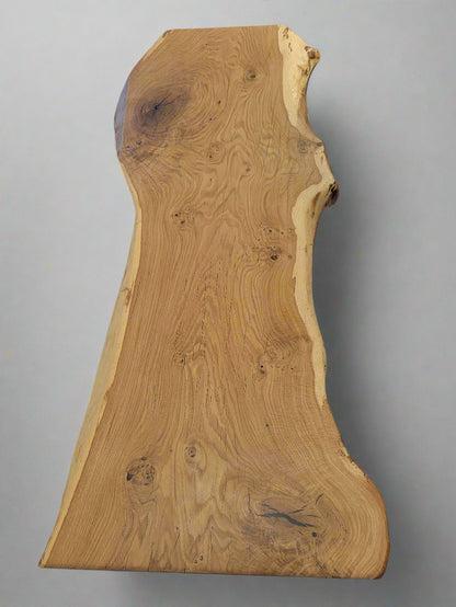 Wooden slab with natural grain pattern on a white surface